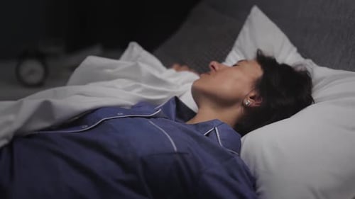 Woman Sleeping Peacefully in Bed at Night