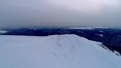 Aerial View of Snow-Capped Mountains in Winter
