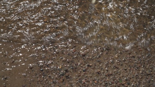 Water Flowing on the Brown Sand