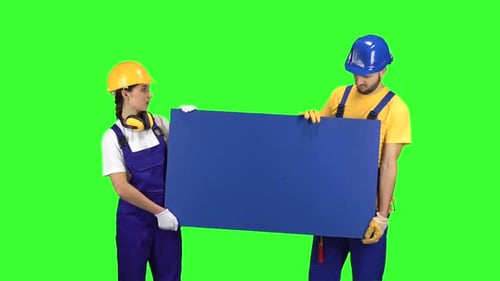 Engenners of the Guy with the Girl Touting the Product and Show Their Thumbs Down . Green Screen