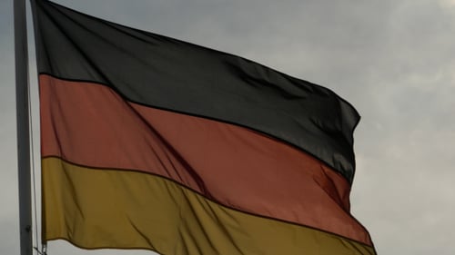 German Flag Waving Against Cloudy Sky