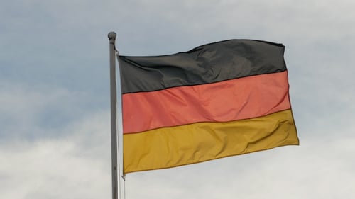 German Flag Waving Against Cloudy Sky