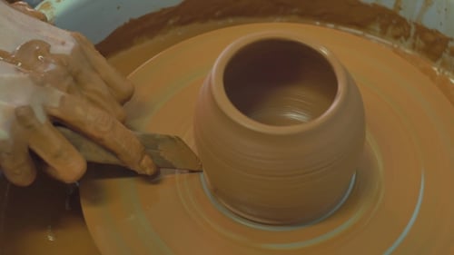 Potter Shaping Clay on a Spinning Wheel