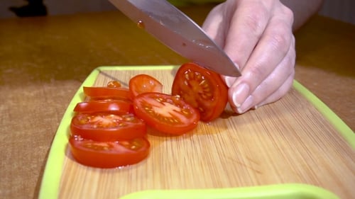 Slicing Fresh Tomatoes on a Cutting Board