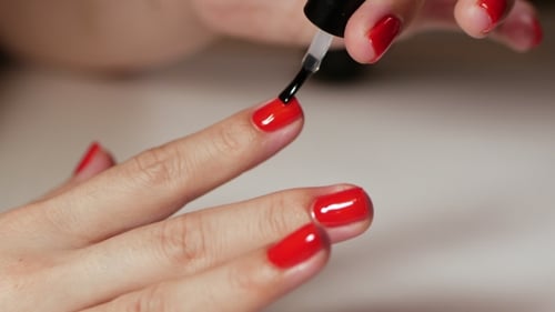 Female Hands Manicure with Red Nails View on White Background. Classic Color Manicure