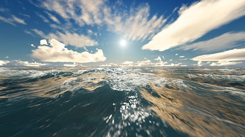 Dynamic Ocean Waves Under Sunny Blue Sky