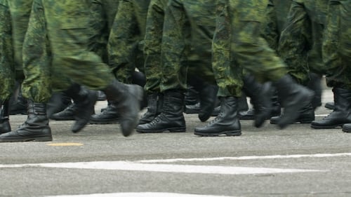 Soldiers Walking By the Street
