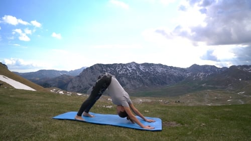 Woman Doing Yoga on Mountain Top