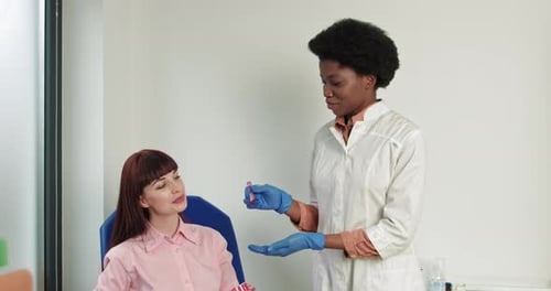 Medical Professional with Patient Holding Blood Sample Vial