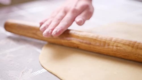 Hand Rolling Dough with Wooden Rolling Pin
