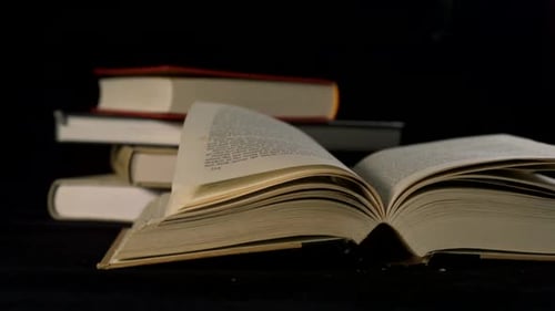 Pages Flipping in Book on Black Background