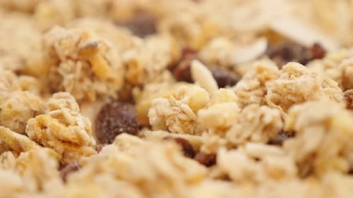 Muesli crunch mix with raisins and other dried fruits food background 4K 3840X2160 UltraHD tilting
