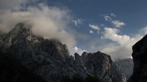 Scenic Mountain Range with Clouds and Sunlight