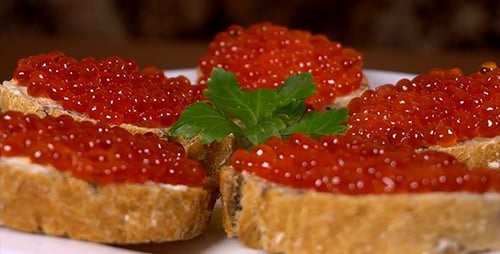 Red Caviar Appetizers on Bread Close Up