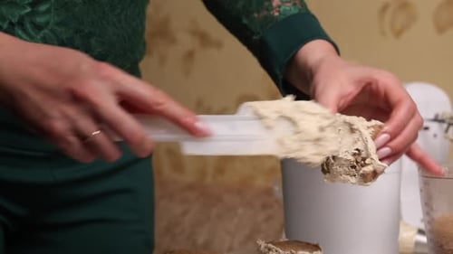 A Woman Makes A Biscuit Cake. Applies Butter Cream To The Workpieces. Close Up