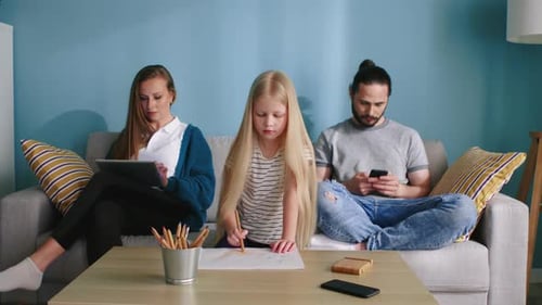 Family Using Technology Together on Couch