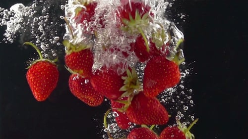 Ripe Strawberries Falling through the Water.