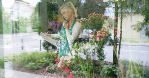 Woman in Floral Shop Talking Phone
