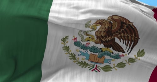 Waving Mexican Flag on Blue Sky Background