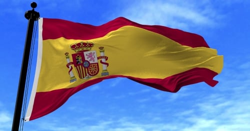 Waving Flag of Spain on Blue Sky