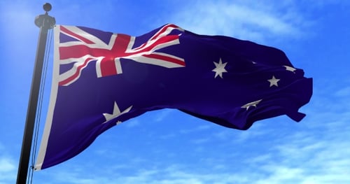 Realistic Waving Australian Flag on Flagpole Against Blue Sky
