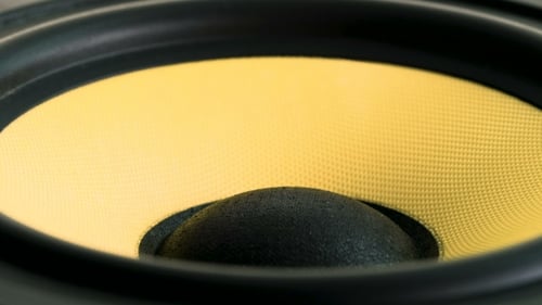Vibrant Yellow Speaker Diaphragm Pulsating in Close-up