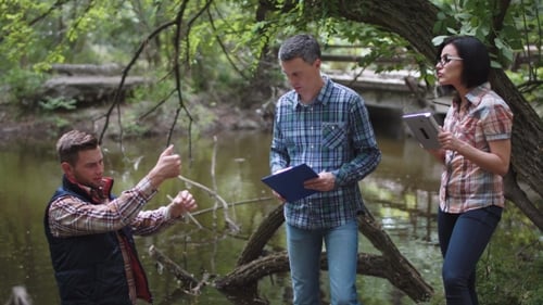 Three Scientists Exploring Water in Lake