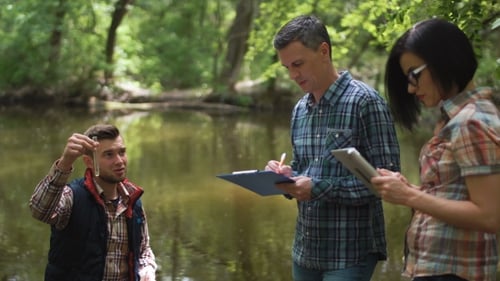 Three Scientists Exploring Water in Lake
