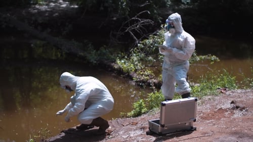 Scientists Taking Water Sample in Protective Gear