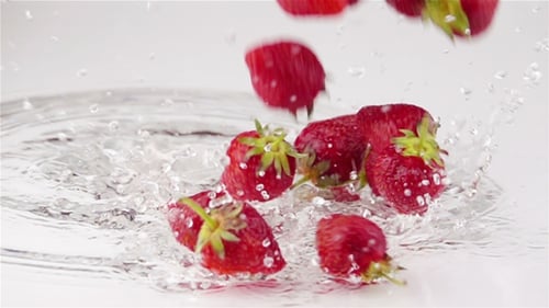 Des fraises mûres tombent sur la table