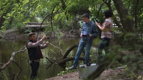 Three Scientists Exploring Water in Lake