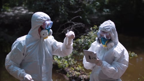 Scientists in Protective Suits Testing Water