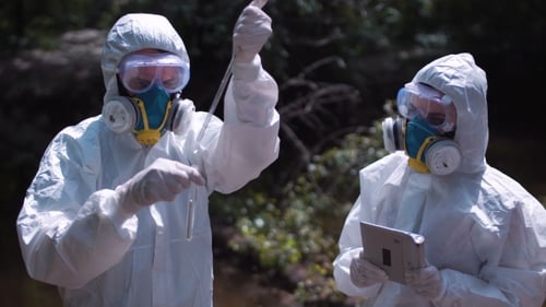 Scientists in Hazmat Suits Take Water Sample
