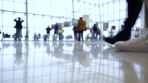 People Walk Inside a Bright, Modern Building