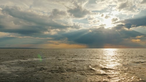 Incredible Sunset By the Sea, the Rays of the Sun Shine From a Thundercloud