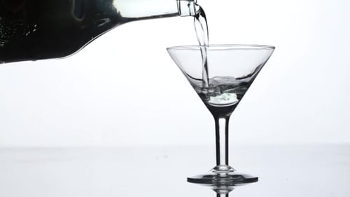 Pouring Clear Drink into Martini Glass