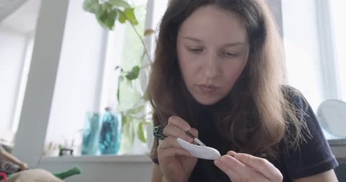 Woman Sculpting Clay Art Piece Indoors