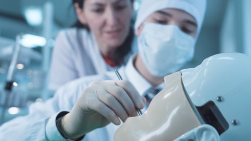 Étudiant en médecine dentaire pratiquant sur un mannequin
