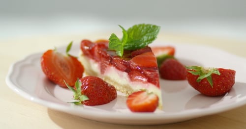 Delicious Strawberry Cheesecake Slice with Fresh Mint