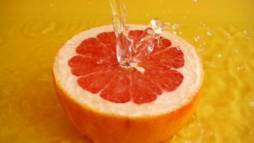 Water Pouring on Half Grapefruit Fruit Slice