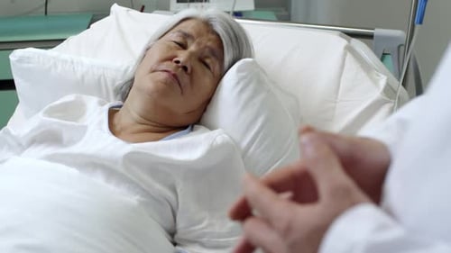 Sick Senior Patient and Doctor Shaking Hands