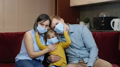 Family Puts On Protective Masks Indoors