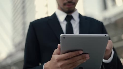 Young Adult Using Tablet in Urban Setting