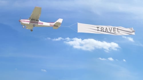 Small Propeller Airplane Towing Banner with TRAVEL Caption in the Sky