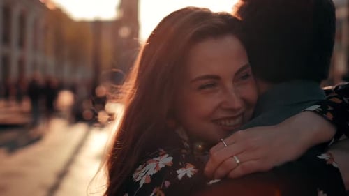 Charming Brunette Woman with Freckles Running To Hug Her Boyfriend at Urban Street. Look at Camera