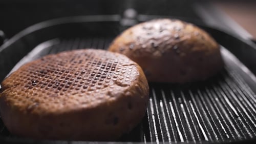 Burger Buns Toasting on a Cast Iron Skillet