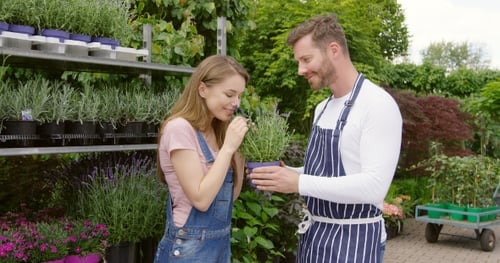 Woman Sniffing Potted Flower