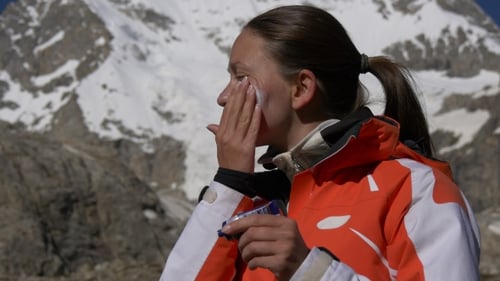 Woman in Mountains Applying Sunscreen