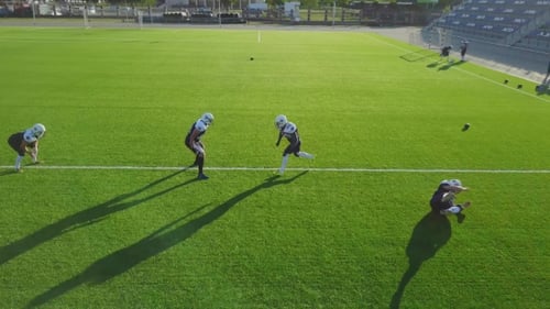 Aerial Shooting with a Drone As Players Play Football on the Field