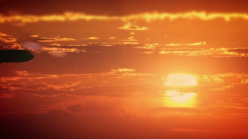 The Airplane Flies In The Orange Sky